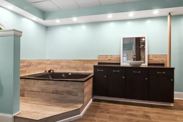 a bathroom with a sink a toilet and a mirror