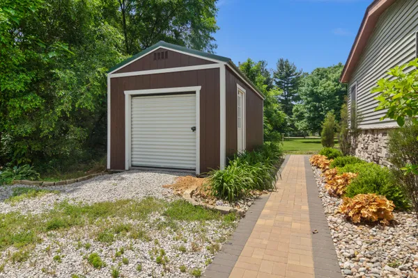 a backyard of a house with garden and garage