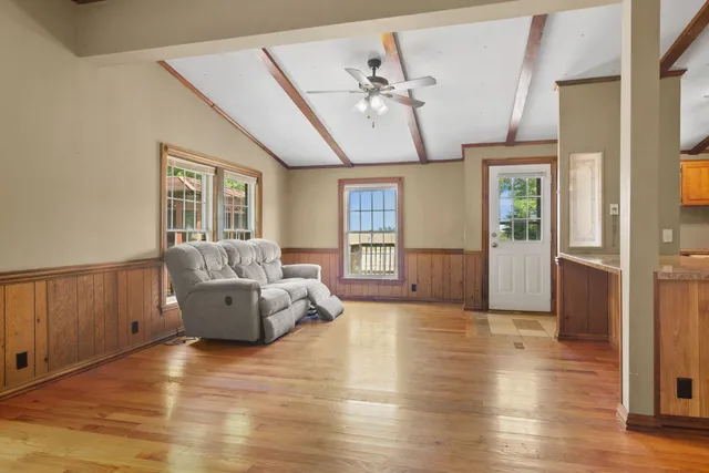 a living room with furniture and wooden floor