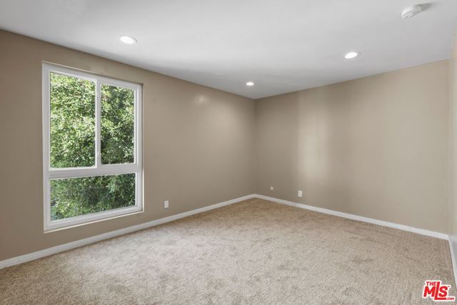 an empty room with large windows