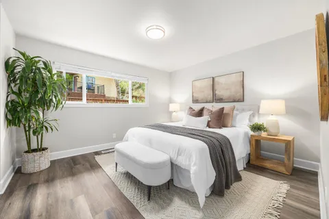 a bed room with a bed and a potted plant