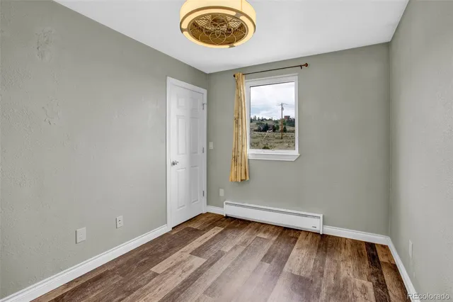 wooden floor in a room next to a window