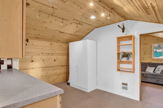 a view of a hallway with a refrigerator and a stove
