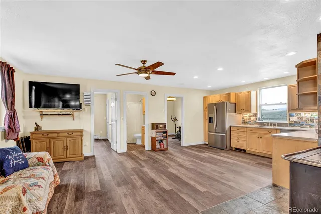 a kitchen with stainless steel appliances a refrigerator sink and cabinets