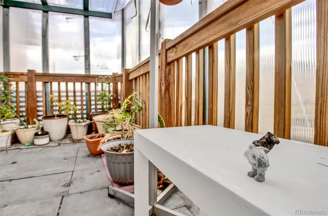 a living room with a refrigerator and a table