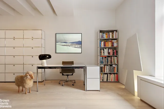 a view of a workspace with furniture and cabinet