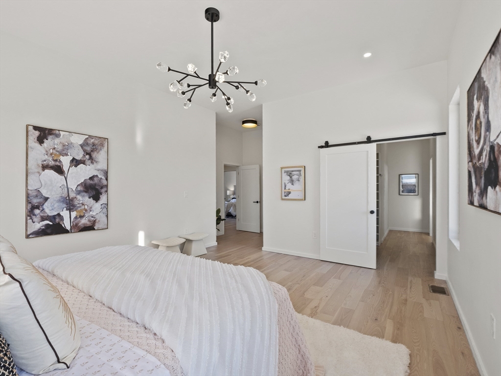 225 Walnut Street Saugus, MA 01906 - Photo 24 of 42 a bedroom with a bed and a chandelier