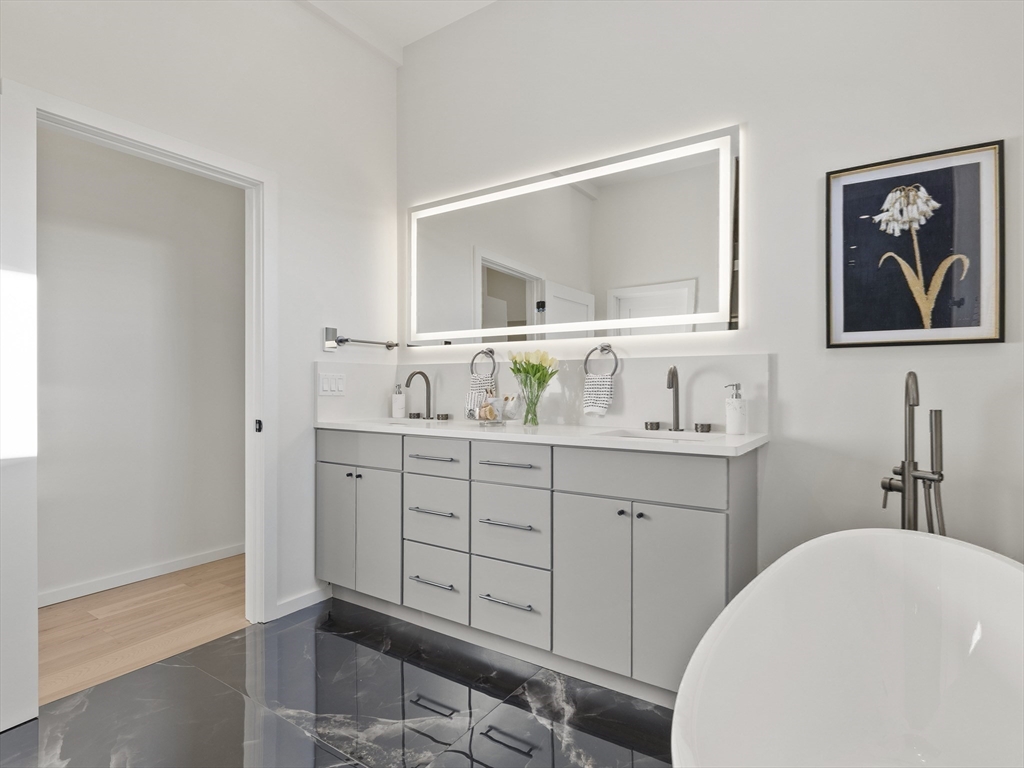 225 Walnut Street Saugus, MA 01906 - Photo 28 of 42 a bathroom with a sink a vanity and a mirror