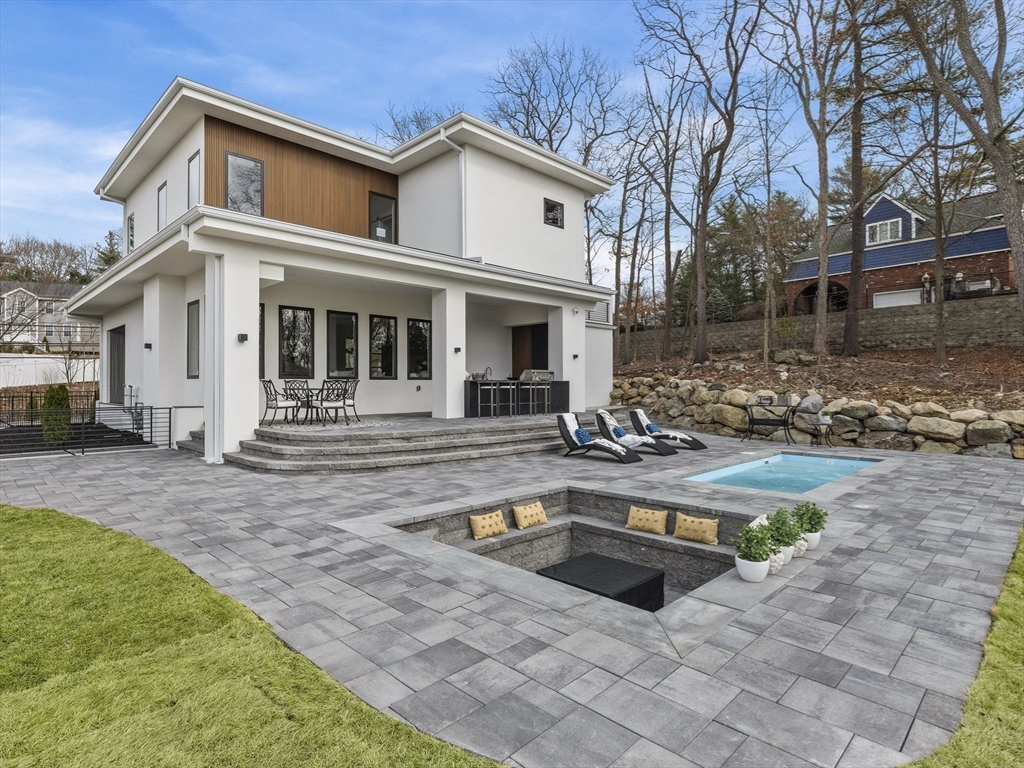 225 Walnut Street Saugus, MA 01906 - Photo 42 of 42 a view of a white house with a yard patio and fire pit