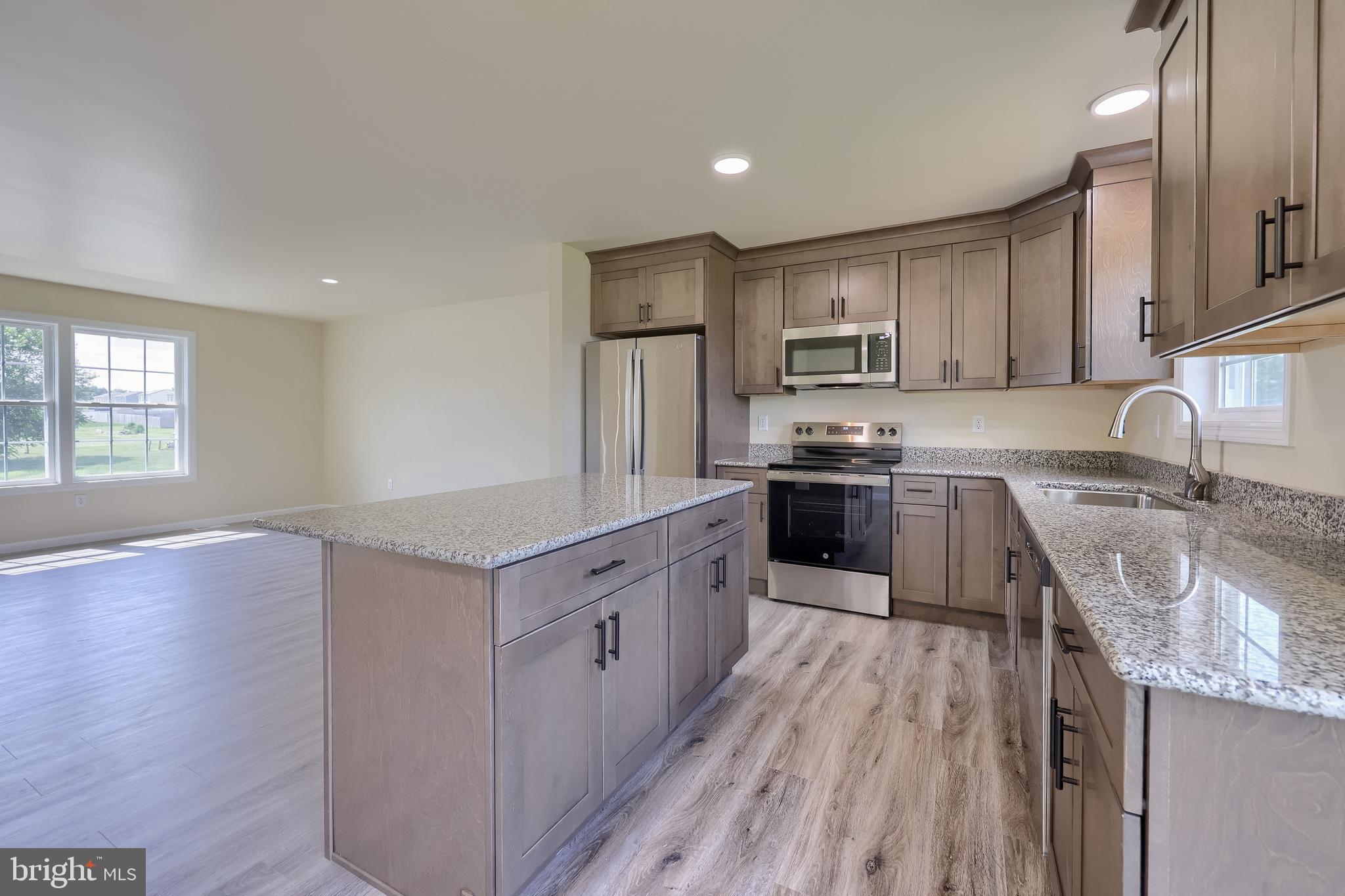 6030 Deborah Drive Spring Grove, PA 17362 - Photo 13 of 34 a kitchen with stainless steel appliances granite countertop a sink stove and refrigerator