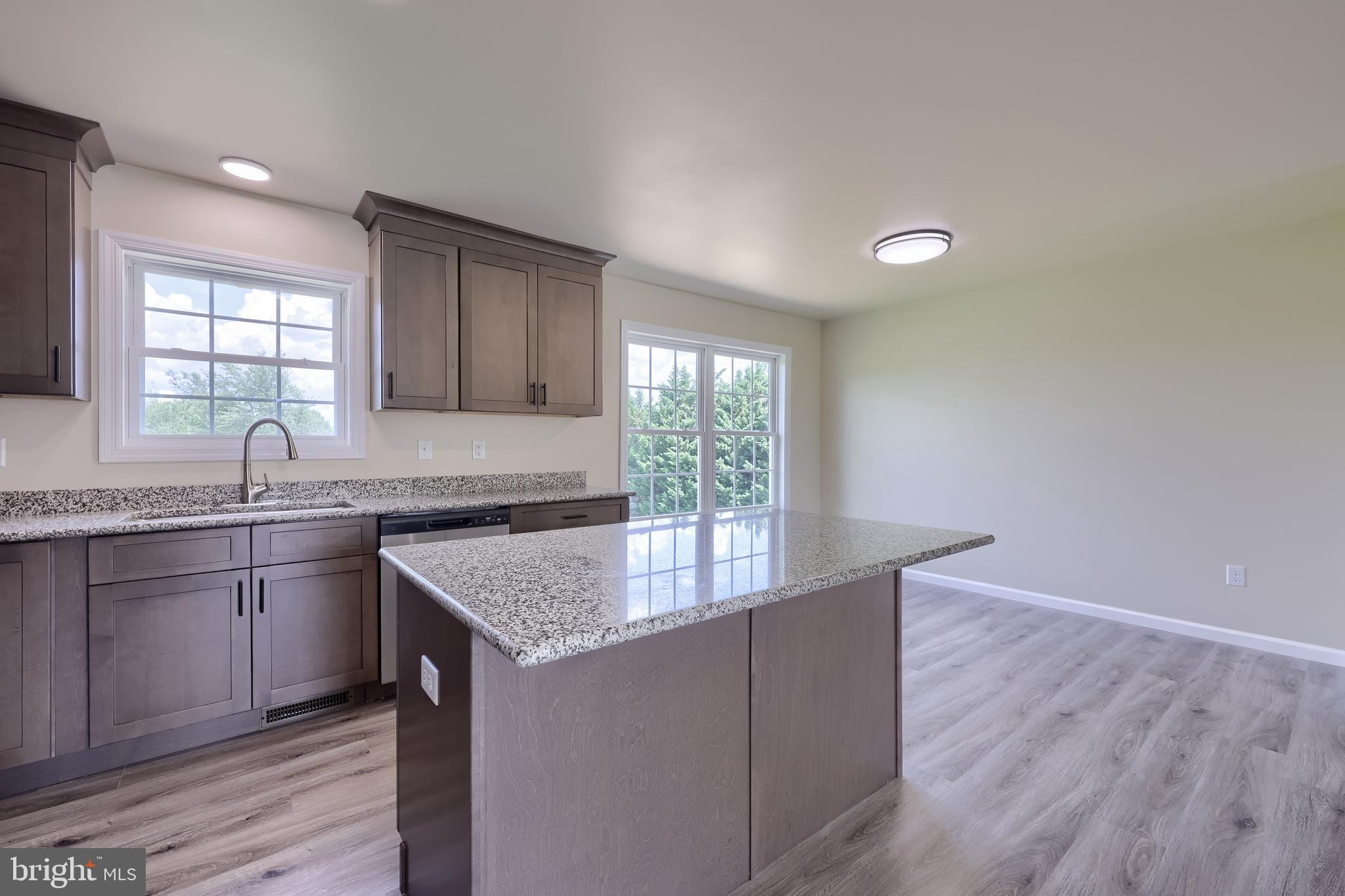 6030 Deborah Drive Spring Grove, PA 17362 - Photo 15 of 34 a kitchen with granite countertop a sink and dishwasher with wooden floor