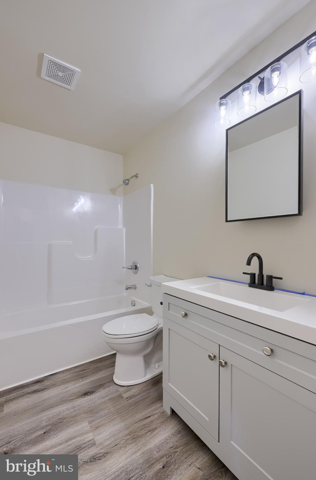 6030 Deborah Drive Spring Grove, PA 17362 - Photo 18 of 34 a bathroom with a toilet a sink a mirror and bathtub