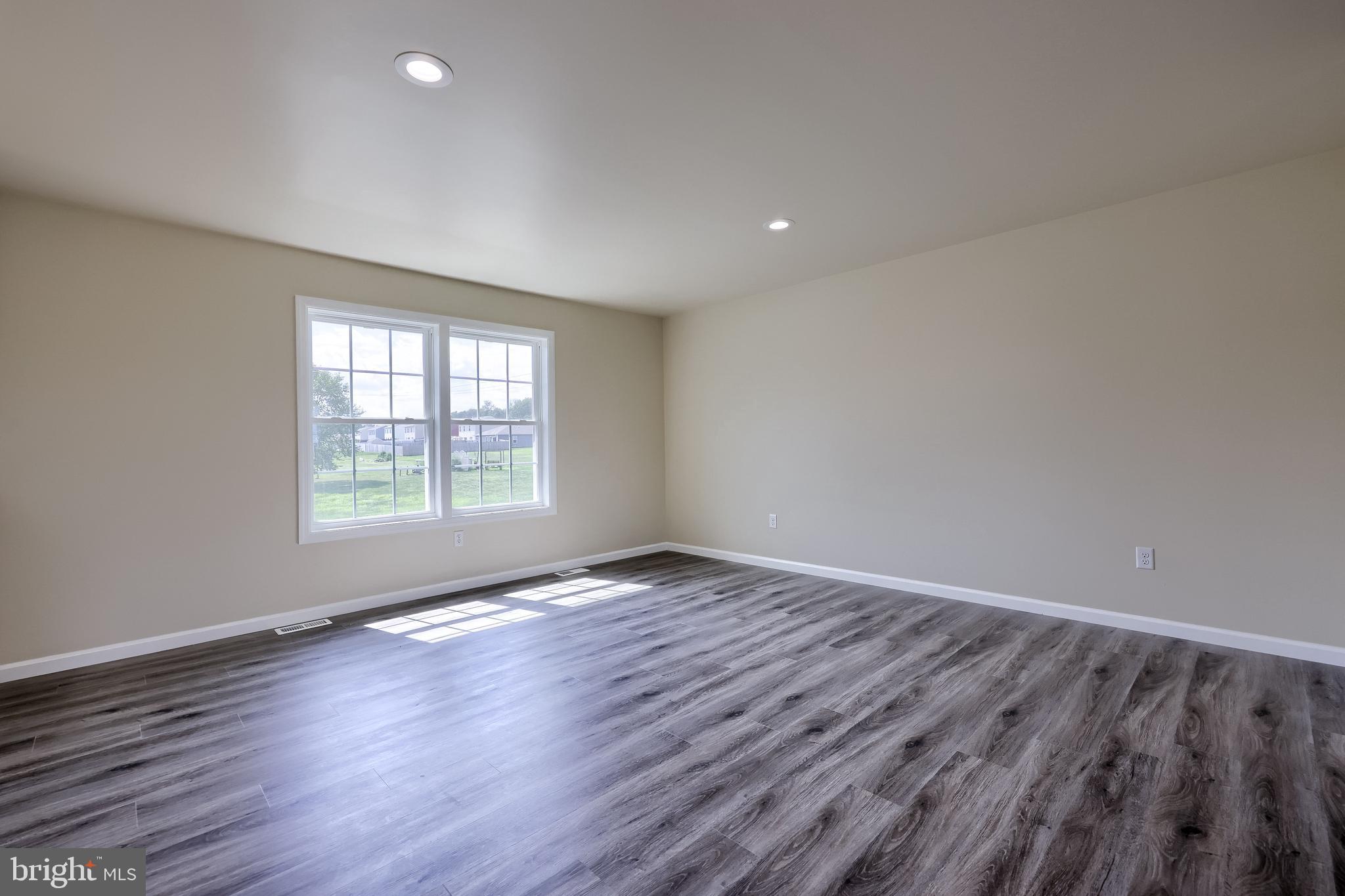 6030 Deborah Drive Spring Grove, PA 17362 - Photo 2 of 34 an empty room with wooden floor and windows