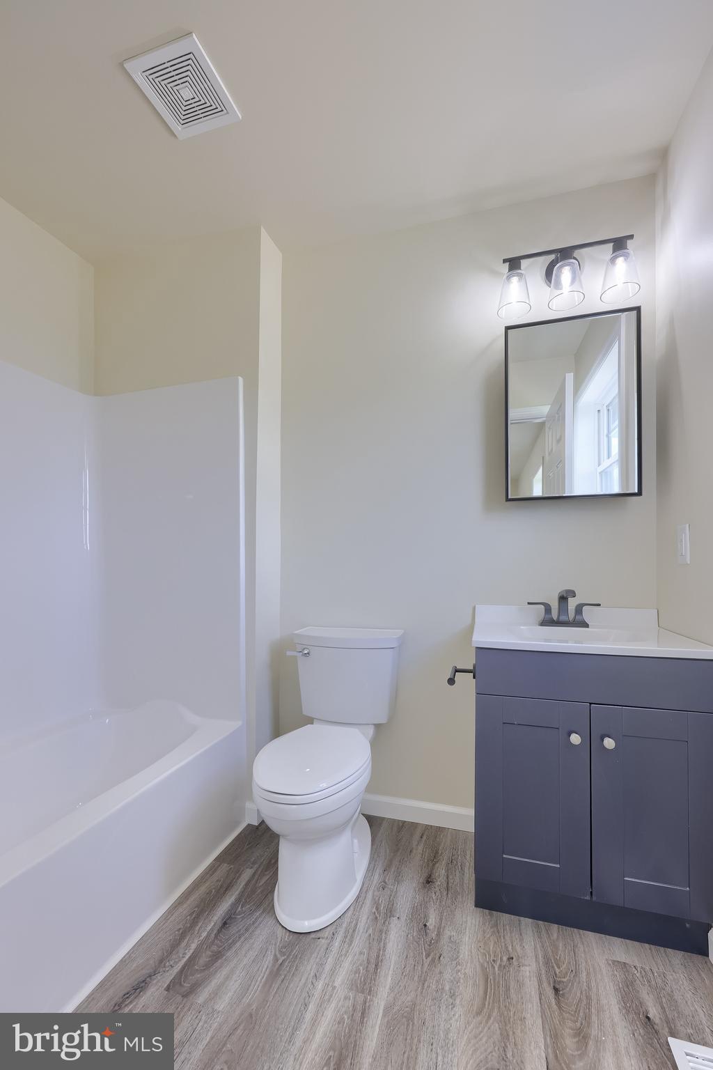 6030 Deborah Drive Spring Grove, PA 17362 - Photo 24 of 34 a bathroom with a toilet a sink a mirror and bathtub