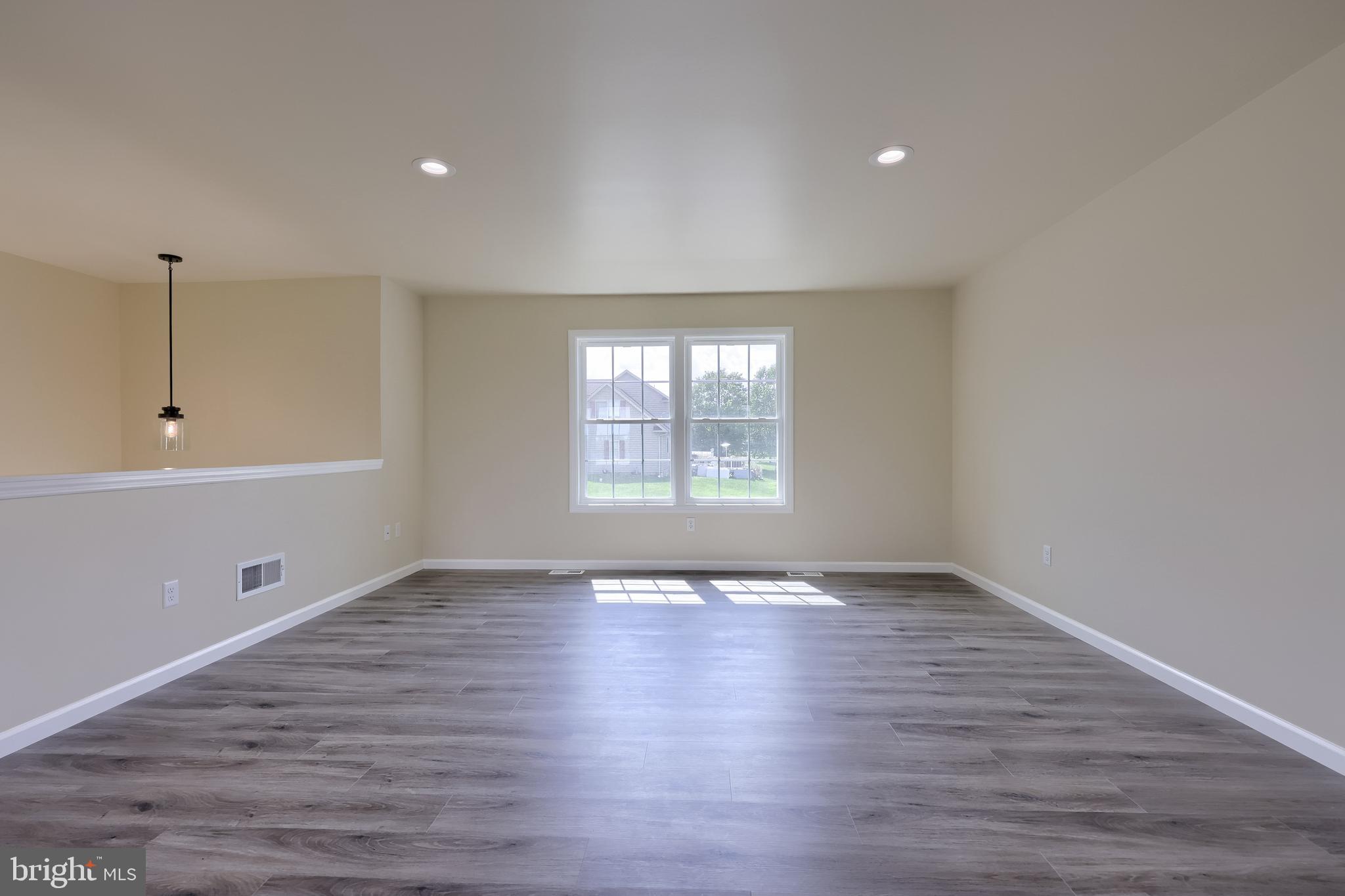 6030 Deborah Drive Spring Grove, PA 17362 - Photo 3 of 34 a view of an empty room with wooden floor and a window