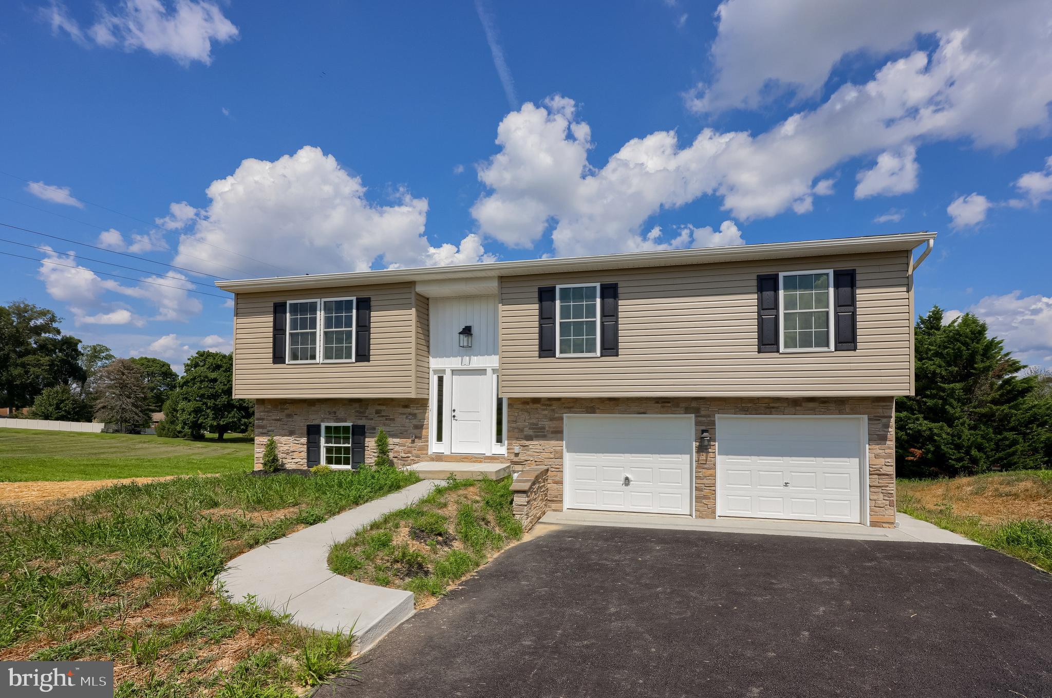 6030 Deborah Drive Spring Grove, PA 17362 - Photo 31 of 34 a front view of a house with a yard and garage