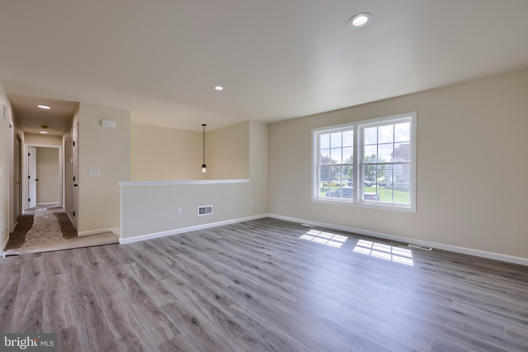 6030 Deborah Drive Spring Grove, PA 17362 - Photo 4 of 34 an empty room with wooden floor and windows