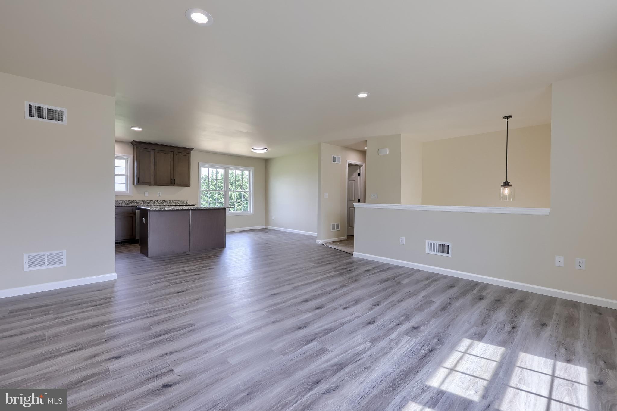 6030 Deborah Drive Spring Grove, PA 17362 - Photo 5 of 34 a view of empty room with wooden floor and kitchen