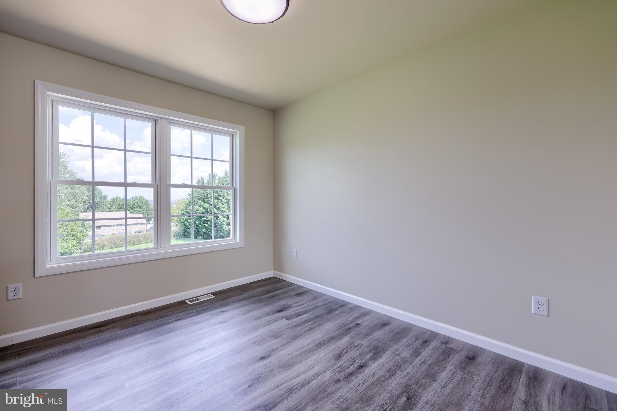 6030 Deborah Drive Spring Grove, PA 17362 - Photo 8 of 34 an empty room with wooden floor and windows