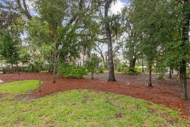 a kitchen with stainless steel appliances wooden floor dining table and chairs