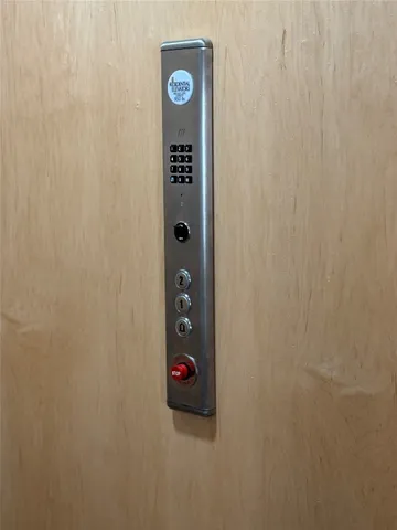 a view of kitchen with kitchen island stainless steel appliances a sink and living room view