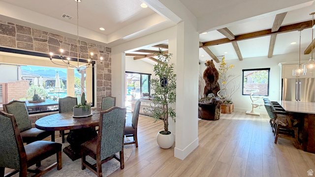 168 South Rancho Santa Fe Virgin, UT 84779 - Photo 13 of 58 Open-concept living area with wood-finish flooring, exposed beam ceiling accents, and a stone accent wall