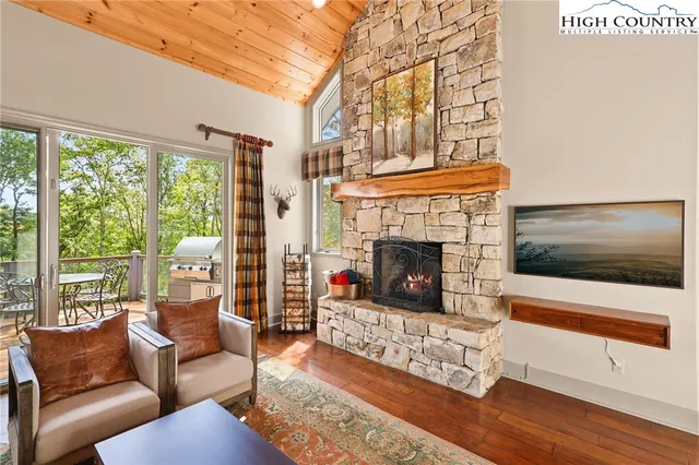 a living room with furniture large window and a fireplace