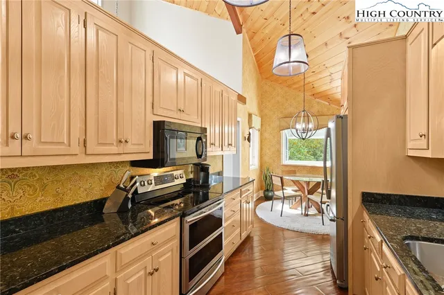 a kitchen with granite countertop a stove a sink and a granite counter tops