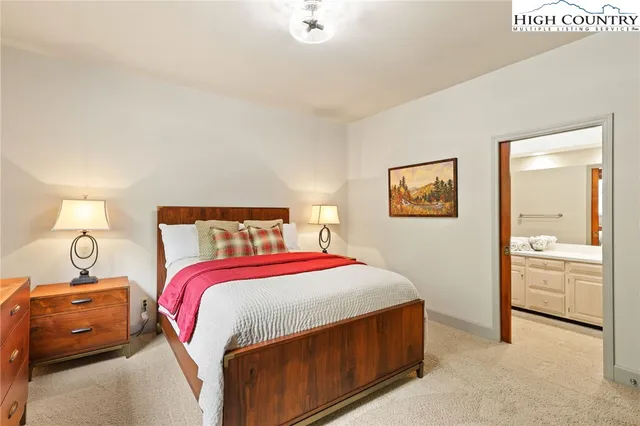 a bedroom with a bed and a lamp