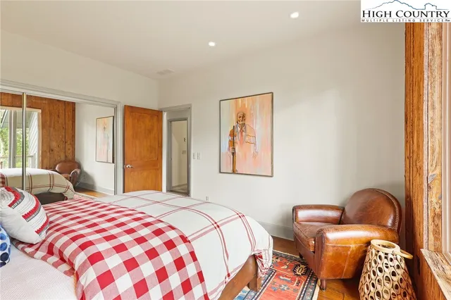 a bedroom with beds and a window