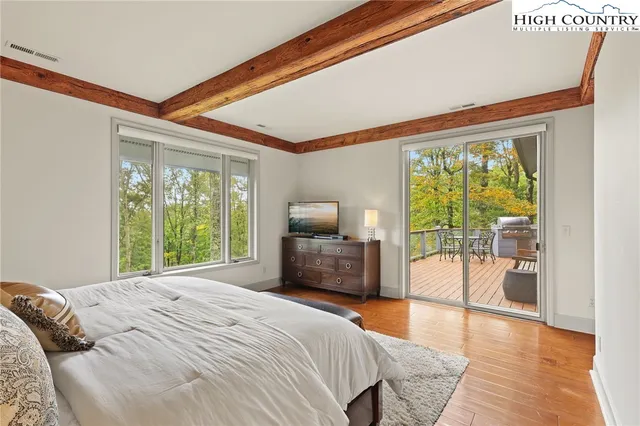 a bedroom with a large bed and a large window