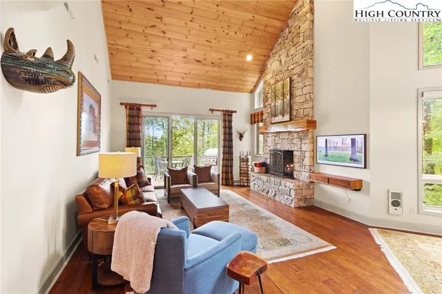 a living room with furniture a fireplace and a table