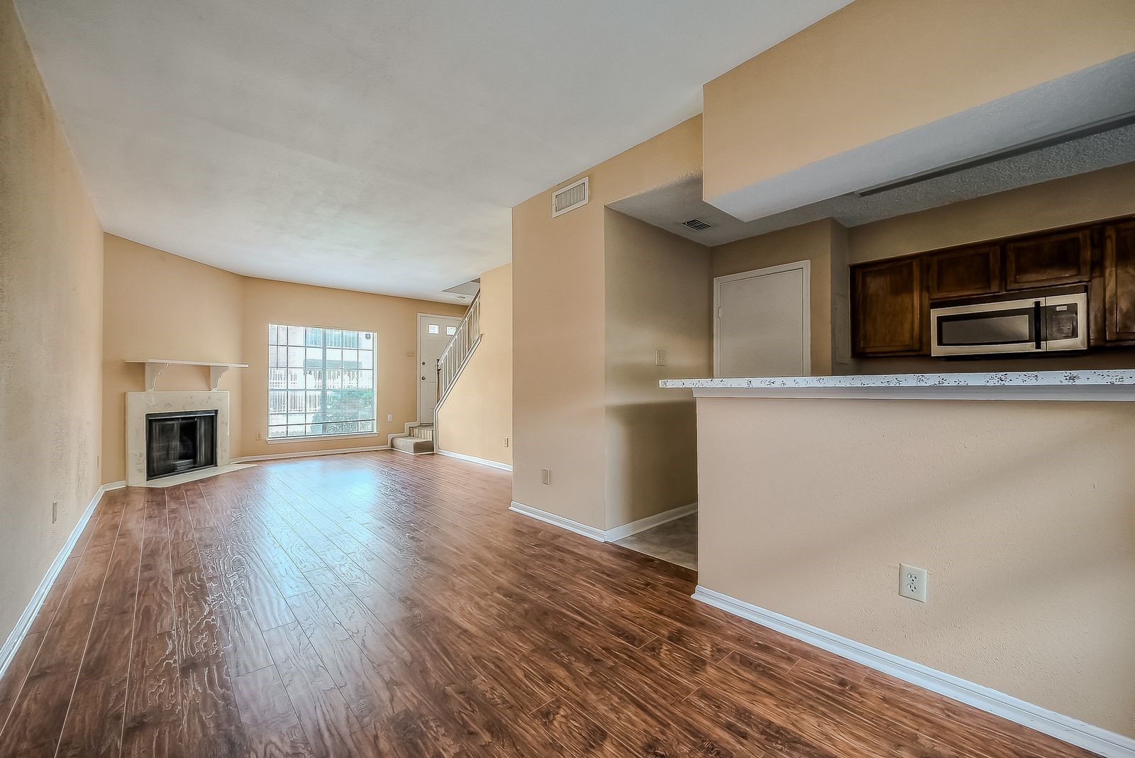11201 Lynbrook Drive, Unit 3202 Houston, TX 77042 - Photo 16 of 22 a view of empty room with wooden floor and fireplace