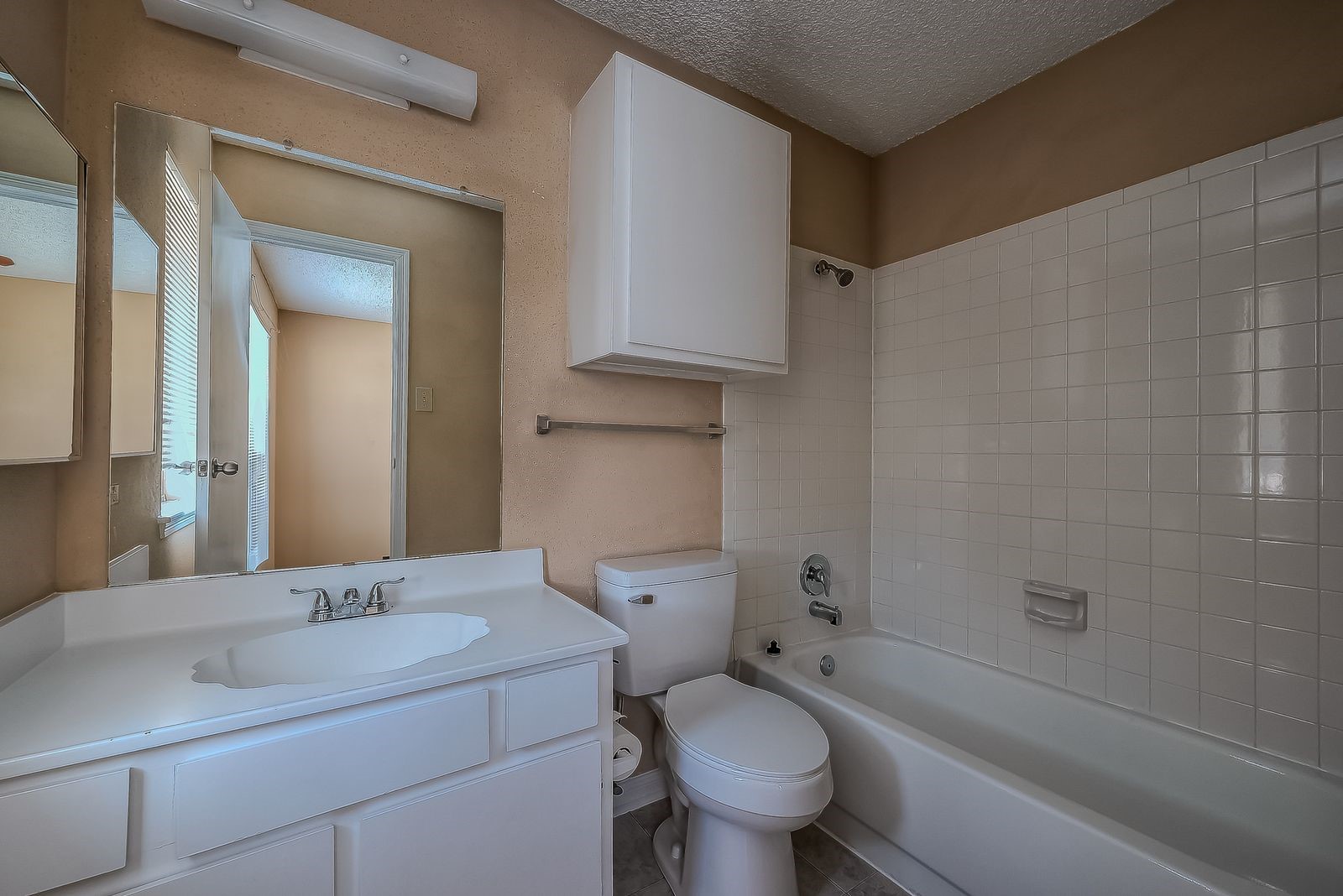 11201 Lynbrook Drive, Unit 3202 Houston, TX 77042 - Photo 17 of 22 a bathroom with a granite countertop toilet sink and mirror