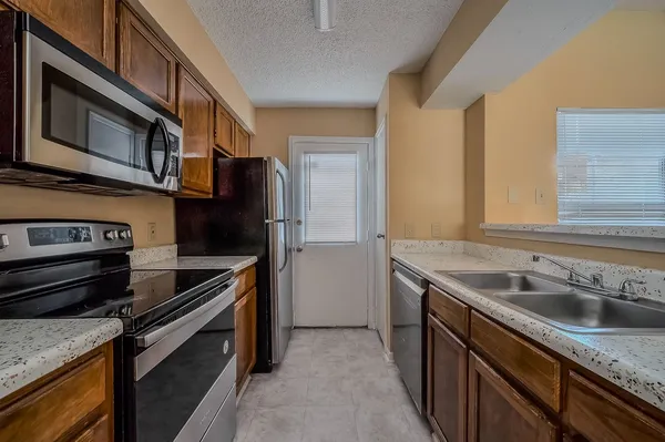 a kitchen that has a sink and a stove