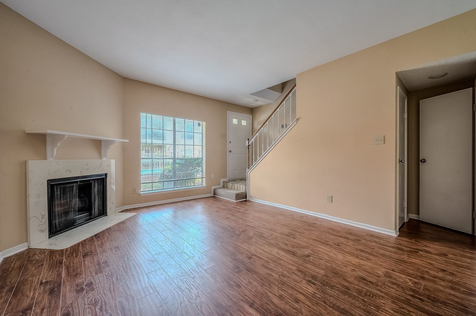 11201 Lynbrook Drive, Unit 3202 Houston, TX 77042 - Photo 10 of 22 an empty room with wooden floor fireplace and windows