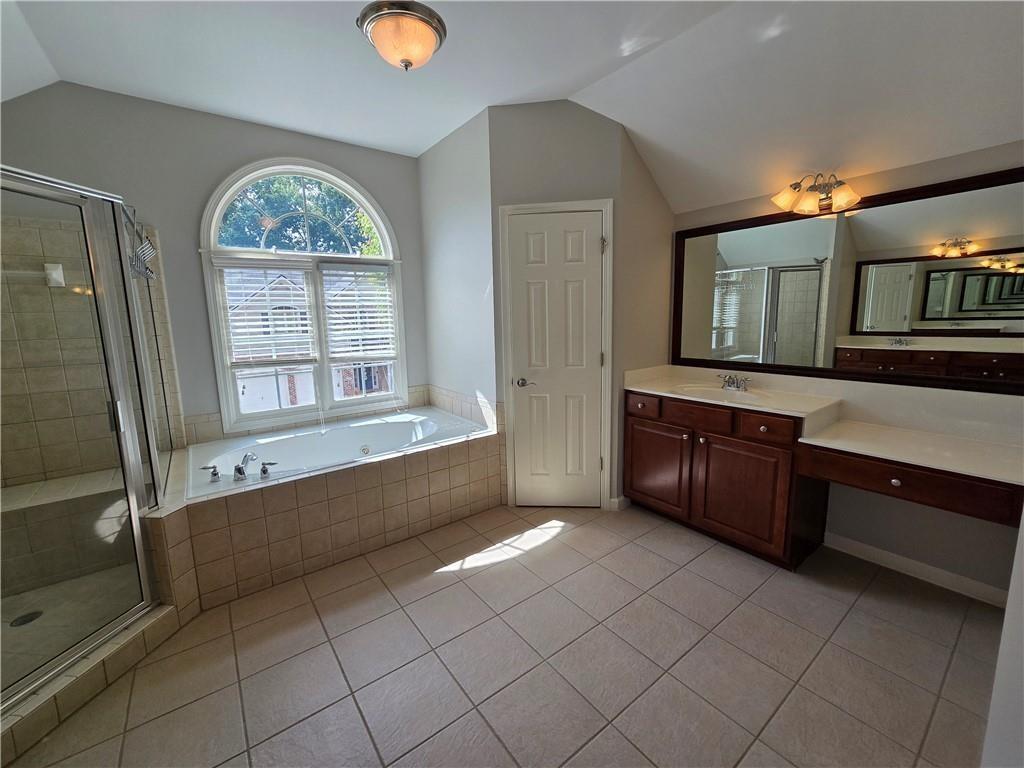 624 Maple Grove Way Marietta, GA 30066 - Photo 15 of 27 a large spacious bathroom with a large tub and shower