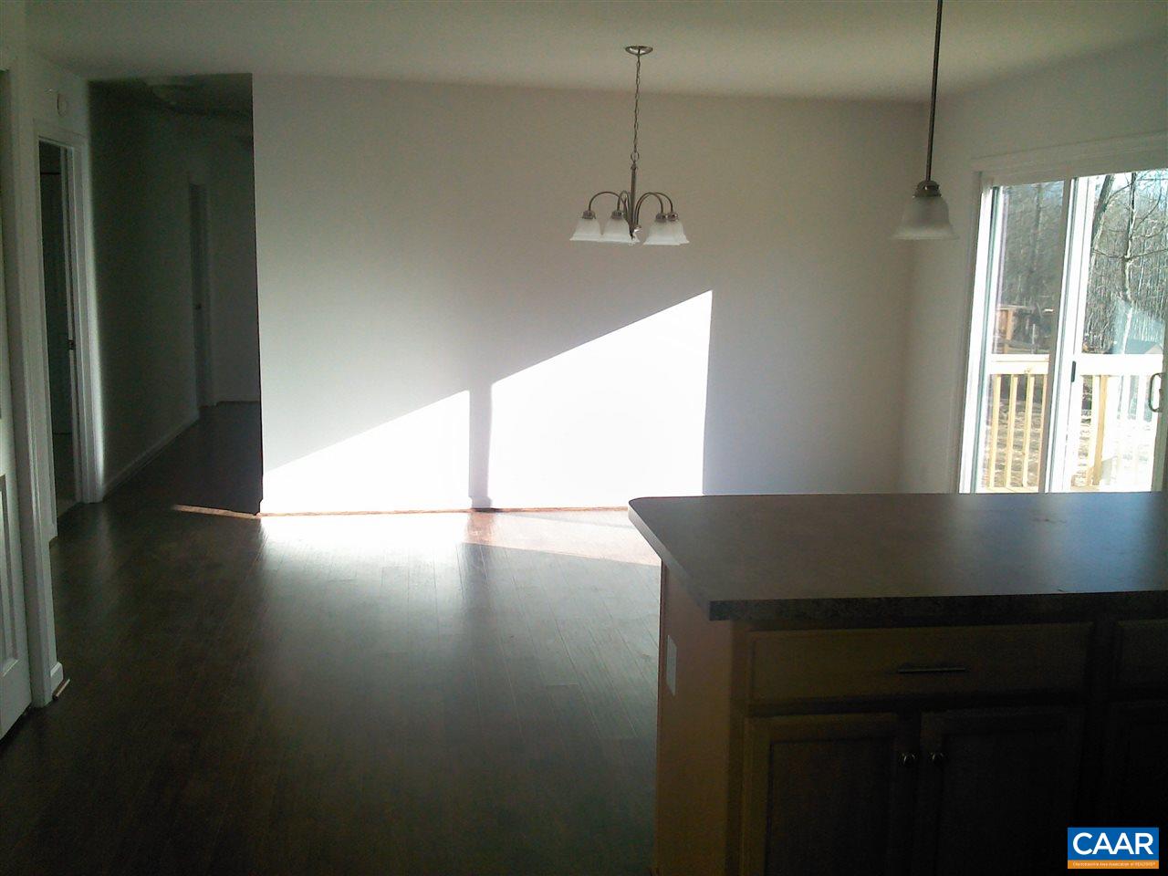130 Jacoby Road Louisa, VA 23093 - Photo 7 of 12 a view of a room with wooden floor windows and a ceiling fan