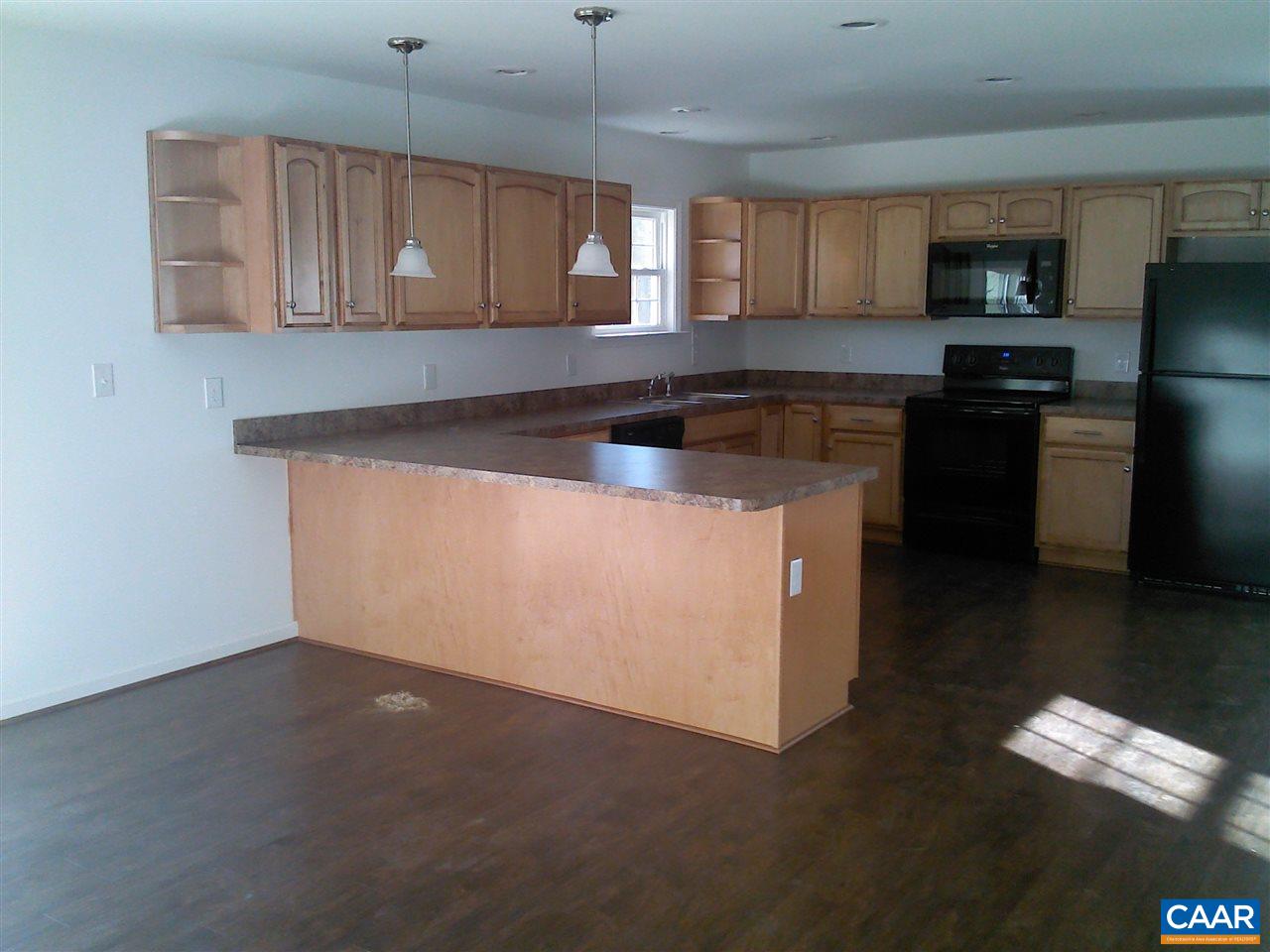 130 Jacoby Road Louisa, VA 23093 - Photo 8 of 12 a kitchen with granite countertop wood cabinets stainless steel appliances and a window