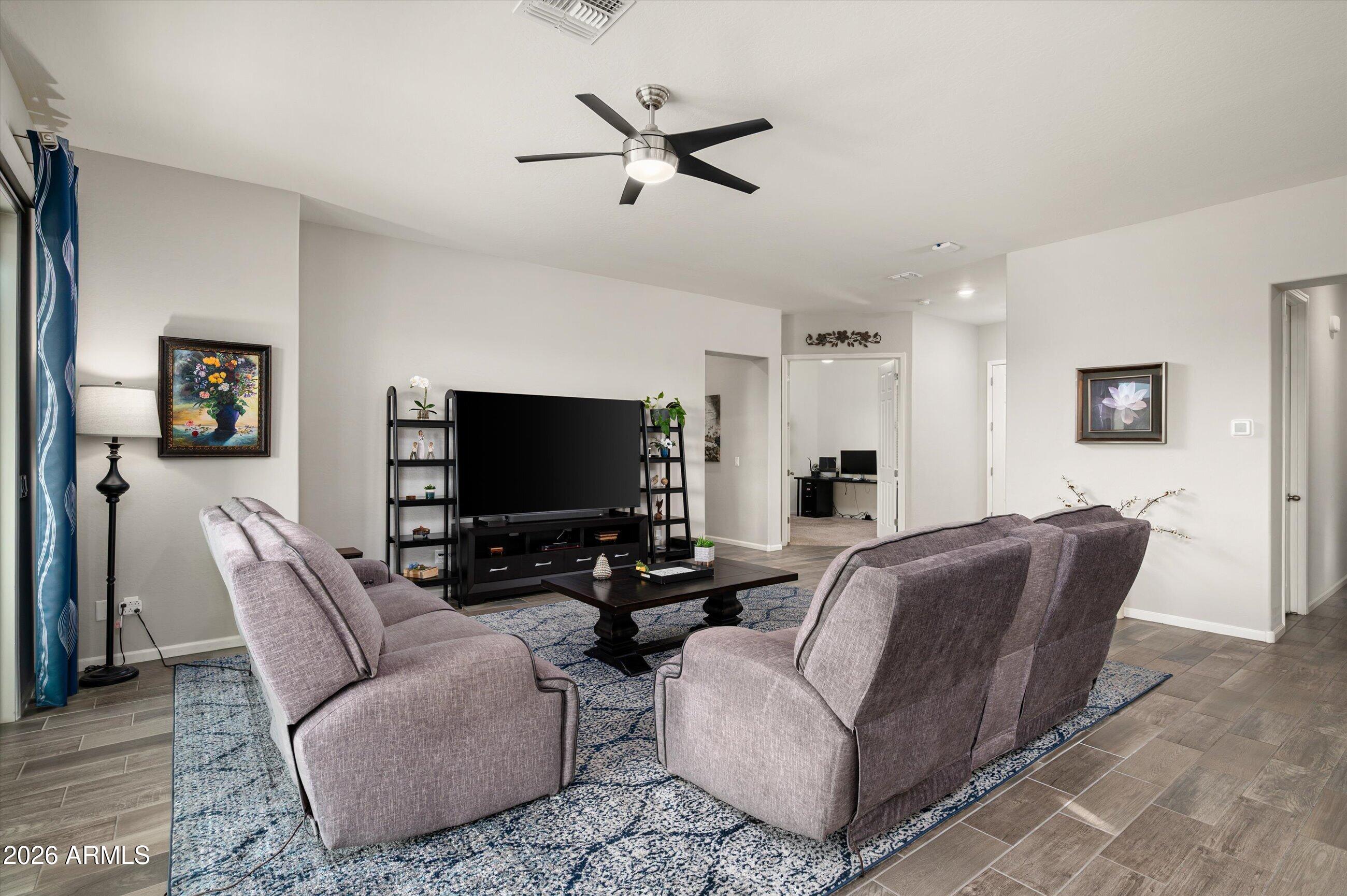 6406 Copper Springs Road Phoenix, AZ 85083 - Photo 10 of 59 a living room with furniture and a flat screen tv