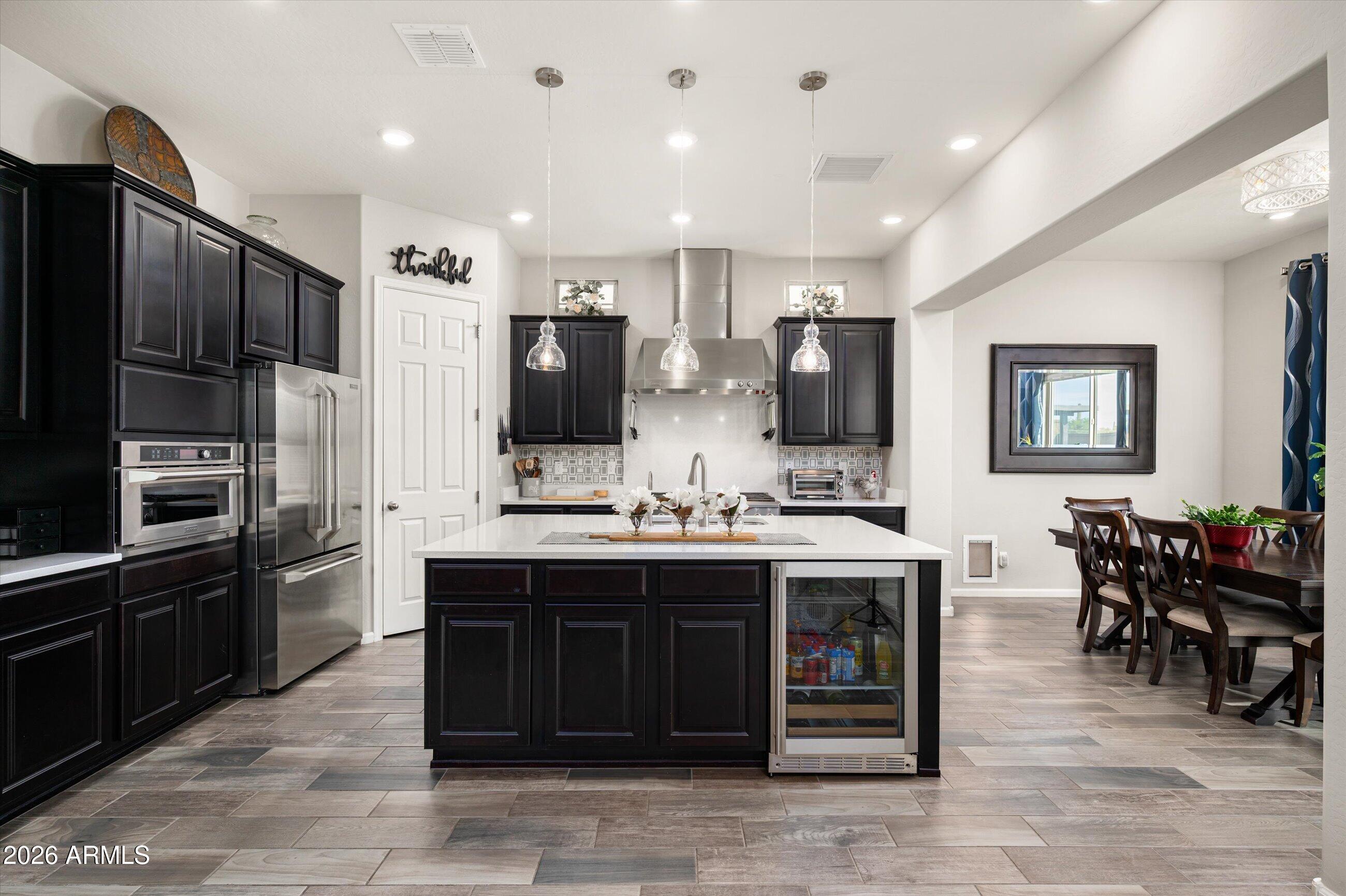 6406 Copper Springs Road Phoenix, AZ 85083 - Photo 11 of 59 a large kitchen with stainless steel appliances granite countertop a stove refrigerator and a microwave