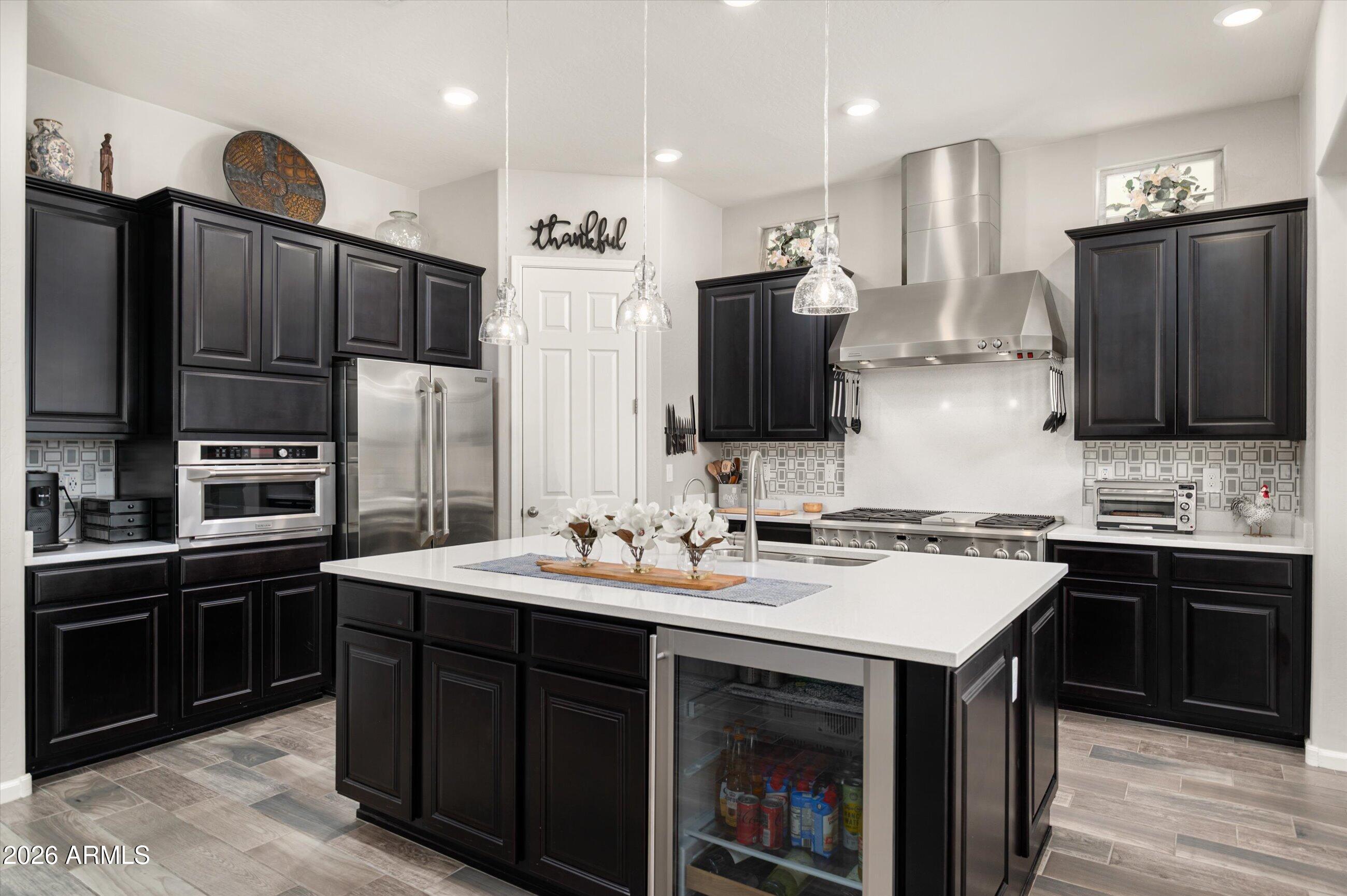 6406 Copper Springs Road Phoenix, AZ 85083 - Photo 12 of 59 a kitchen with stainless steel appliances a sink stove refrigerator and cabinets
