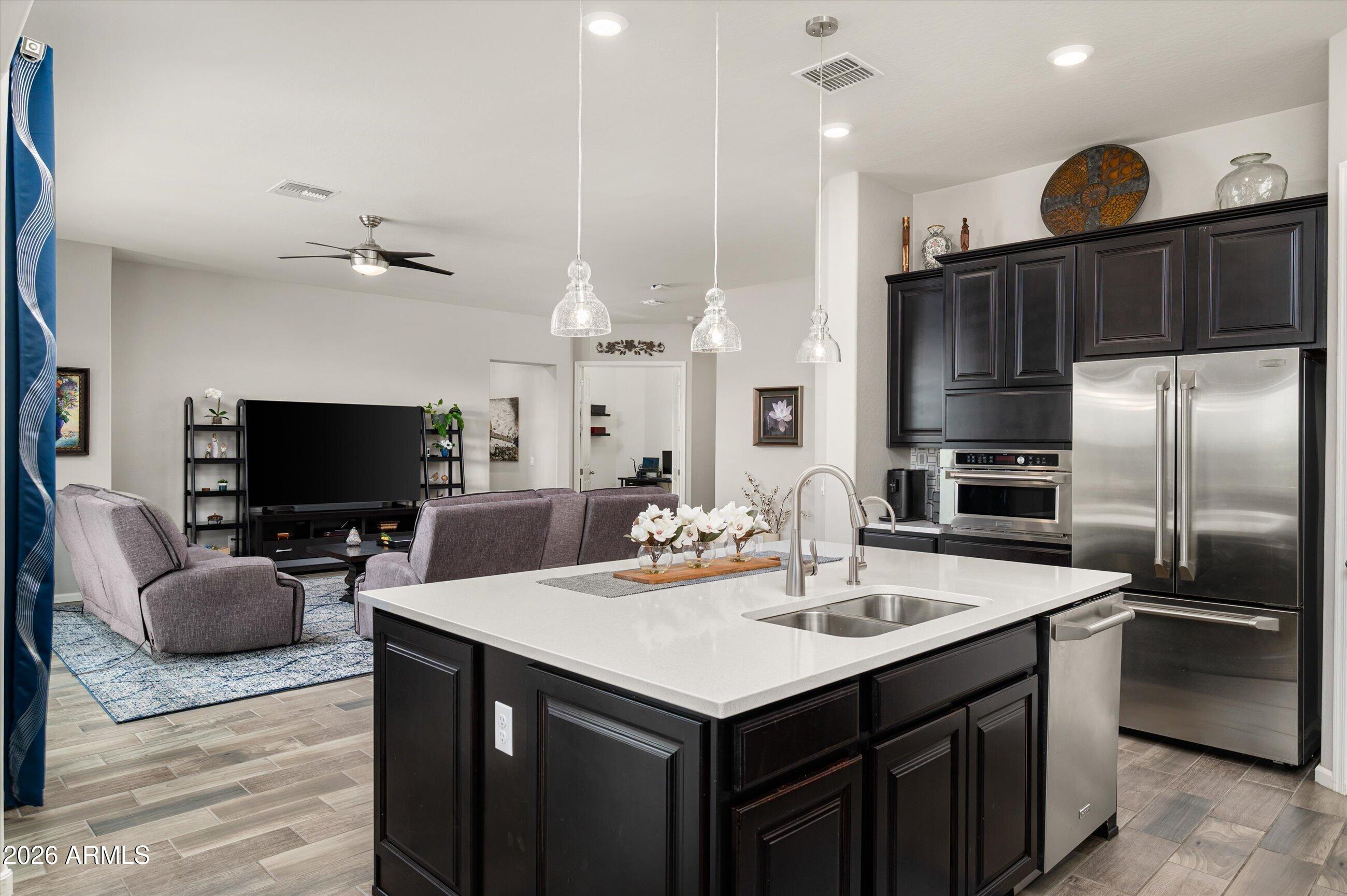 6406 Copper Springs Road Phoenix, AZ 85083 - Photo 16 of 59 a kitchen with a sink stainless steel appliances and chandelier