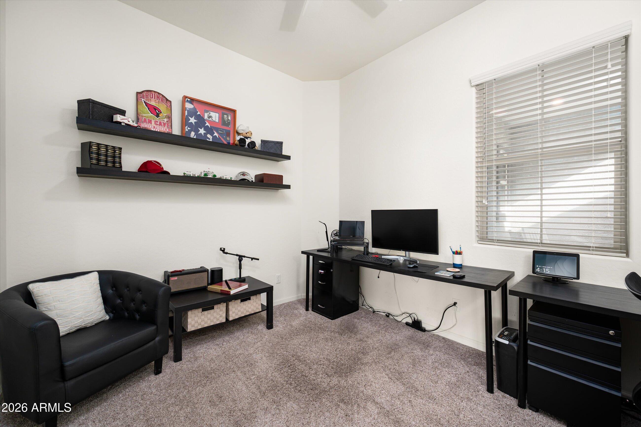 6406 Copper Springs Road Phoenix, AZ 85083 - Photo 18 of 59 a room with furniture and a flat screen tv