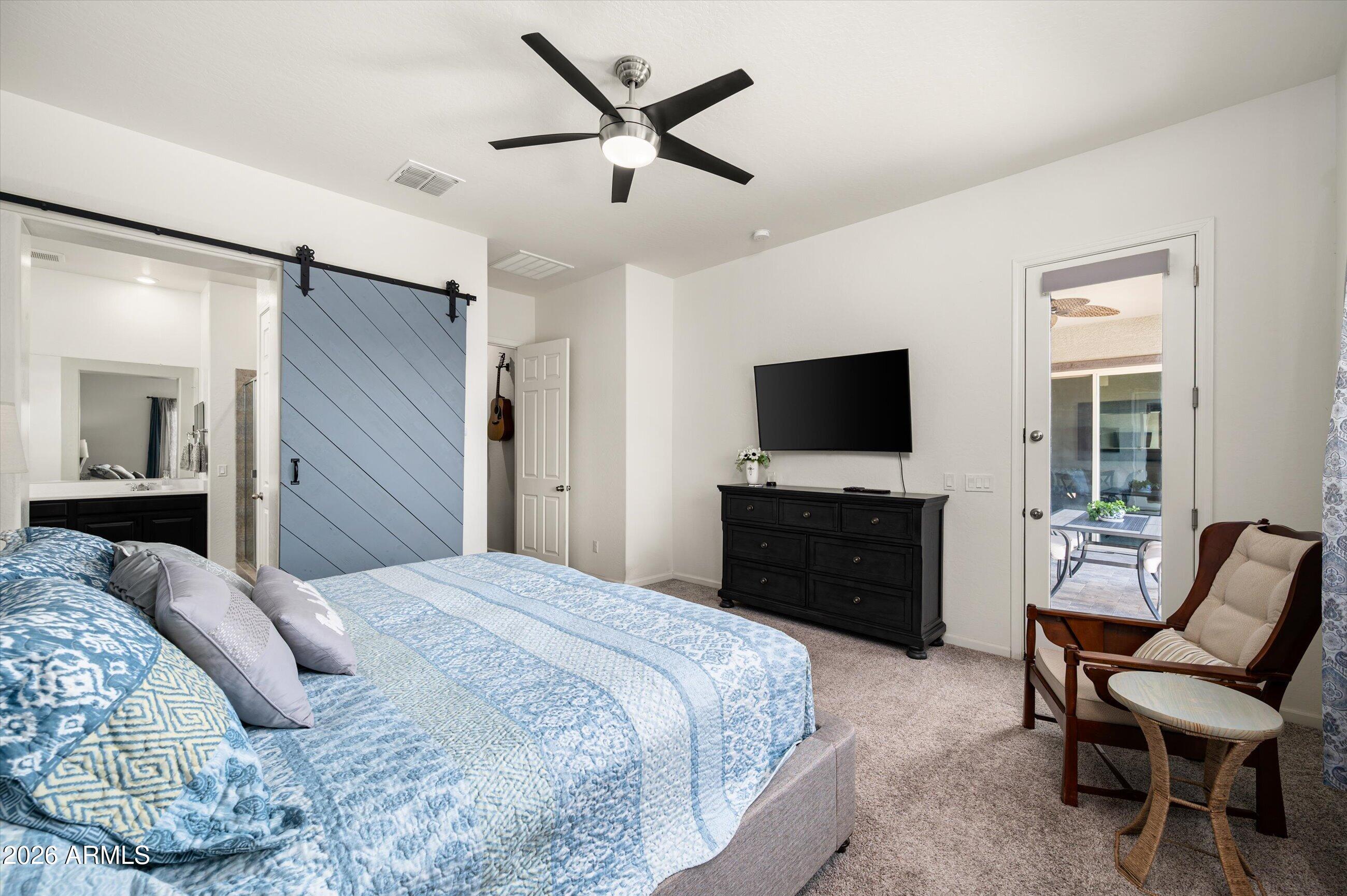 6406 Copper Springs Road Phoenix, AZ 85083 - Photo 20 of 59 a bedroom with a bed and a flat screen tv