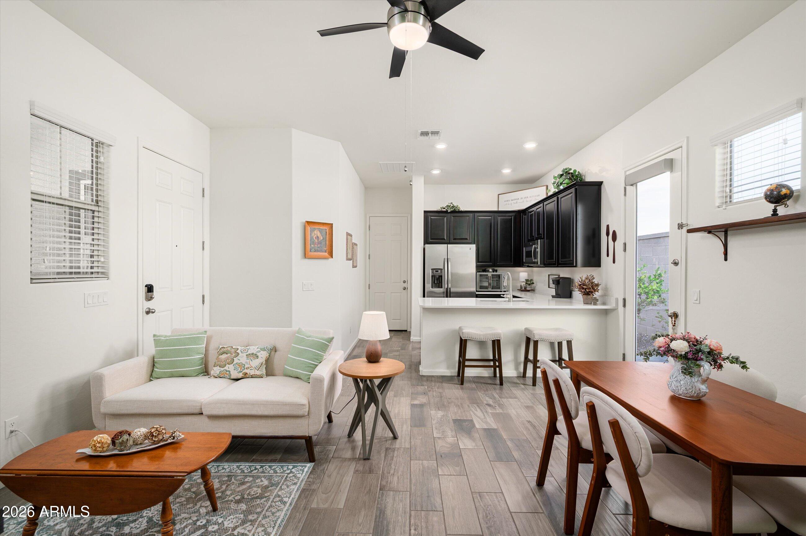6406 Copper Springs Road Phoenix, AZ 85083 - Photo 24 of 59 a living room with stainless steel appliances kitchen island granite countertop furniture and a dining table