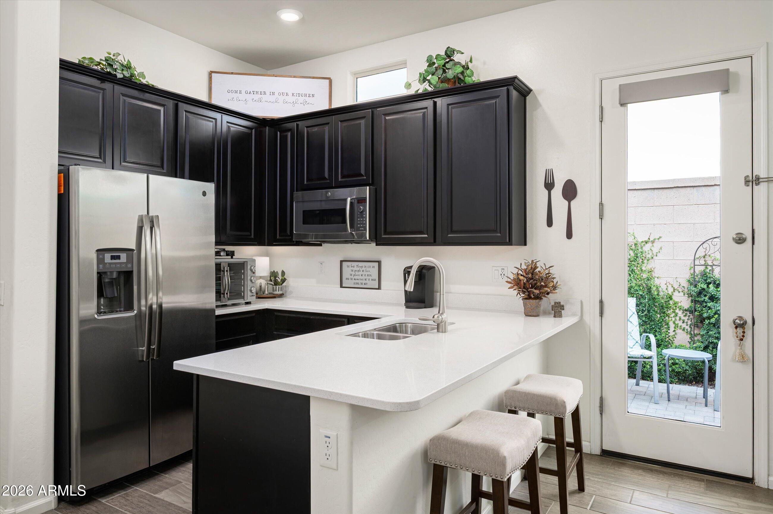 6406 Copper Springs Road Phoenix, AZ 85083 - Photo 25 of 59 a kitchen with stainless steel appliances a refrigerator sink and stove