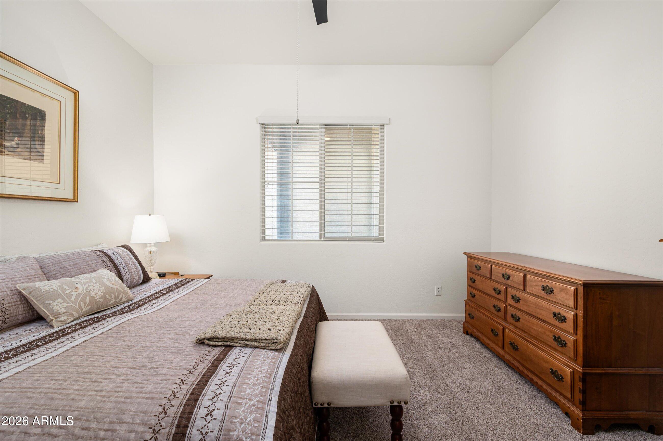 6406 Copper Springs Road Phoenix, AZ 85083 - Photo 28 of 59 a bedroom with bed and a window