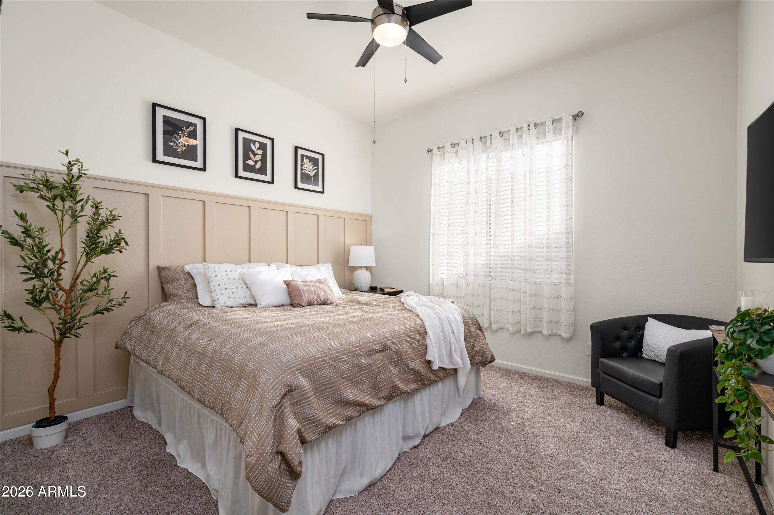 6406 Copper Springs Road Phoenix, AZ 85083 - Photo 30 of 59 a spacious bedroom with a bed and a couch
