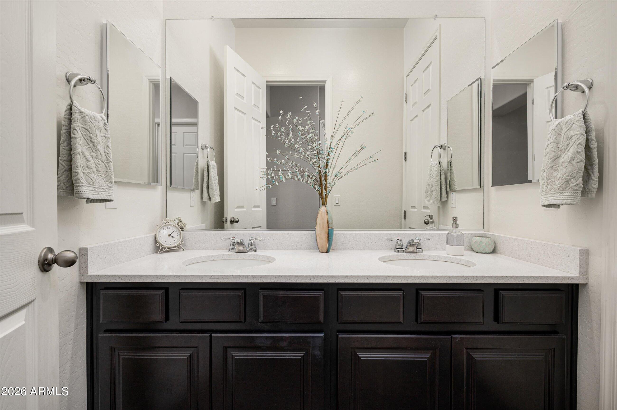 6406 Copper Springs Road Phoenix, AZ 85083 - Photo 31 of 59 a bathroom with a sink and a mirror